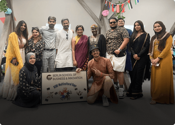 A group of people consisting of counsellors, university delegates, and financial advisors posing happily at an exhibition.