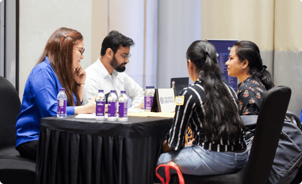 A student and a parent attending a study abroad counselling session with two counsellors.